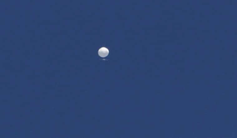 A balloon floats over Columbia, Mo., on Friday, Feb. 3, 2023. A huge, high-altitude Chinese balloon sailed across the U.S. on Friday, drawing severe Pentagon accusations of spying despite China's firm denials. (Anna Griffin/Missourian via AP)