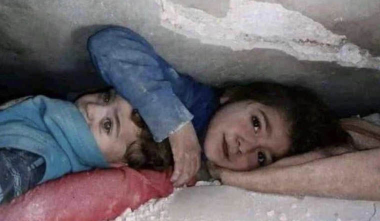 Turkey-Syria earthquake: Photo of Syrian girl protecting brother under rubble goes viral - The Week