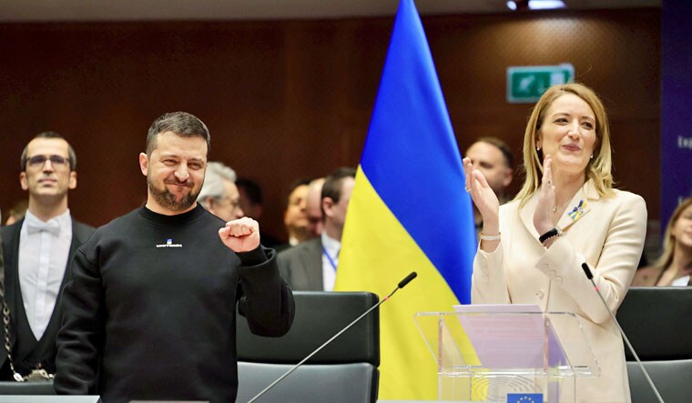 Ukraine's President Volodymyr Zelenskyy, left, gestures as European Parliament's President Roberta Metsola, right, applauds during an EU summit at the European Parliament in Brussels, Belgium, Thursday, Feb. 9, 2023 | AP