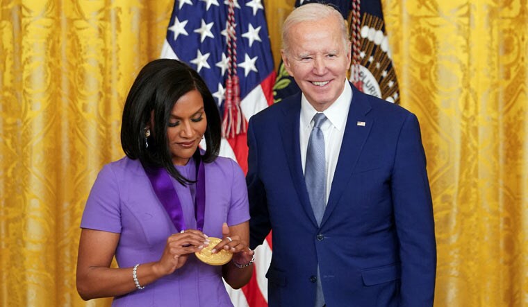 National Medal of Arts recipient actor Mindy Kaling looks at her medal after being presented it by U.S. President Joe Biden during a ceremony in the East Room at the White House in Washington, U.S., March 21, 2023 | AP