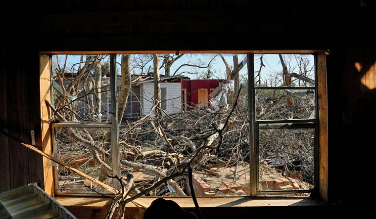 A view out of a blown-out window inside the Miles family home after thunderstorms spawning high straight-line winds and tornadoes ripped across the state in Rolling Fork, Mississippi, U.S., March 25, 2023 | Reuters
