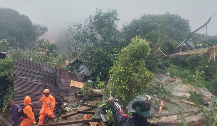 In this frame grab made from video released by Indonesia's National Disaster Management Agency (BNPB), rescuers search for victims at the site where a landslide hit a village on Serasan Island, Natuna regency, Indonesia on Monday, March 6, 2023. The landslide caused by torrential rain killed a number of people and left dozens of others missing on the remote island, disaster officials said. (BNPB via AP)