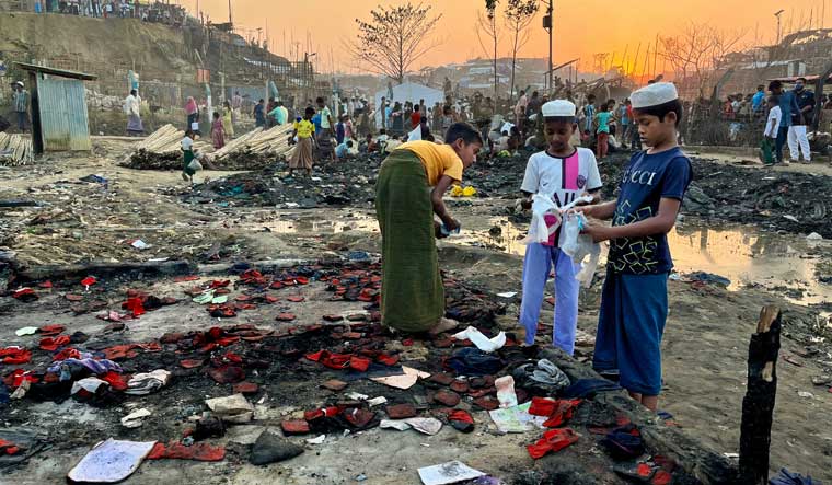 Children sifting through the debris for valuables after a fire that broke out at a Rohingya refugee camp in Cox Baazar, Bangladesh | Salil Bera
