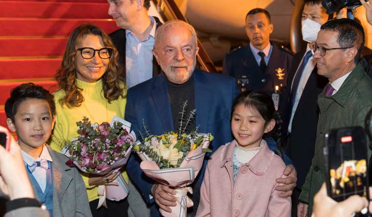 In this photo released by Xinhua News Agency, Brazilian President Luiz Inacio Lula da Silva, center, and first lady Rosangela Silva, second left, being received in Shanghai, China | AP