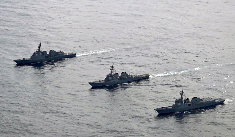 Japan Maritime Self-Defense Force's destroyer Atago, left, U.S. Navy's Arleigh Burke-class guided-missile destroyer USS Barry, center, and South Korean Navy's Aegis destroyer King Sejong the Great, right, sail during a joint missile defense drill among South Korea | AP