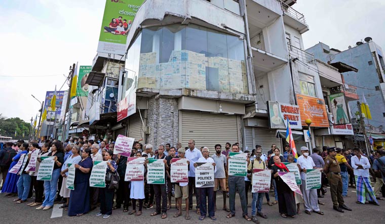 Sri Lankan Catholics hold banner during a silent protest march to mark the fourth year commemoration of the 2019, Easter Sunday bomb attacks on Catholic Churches, in Colombo, Sri Lanka, Friday, April 21, 2023 | AP
