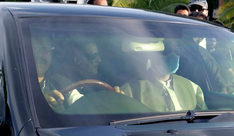 A car carrying Pakistan's former Prime Minister Imran Khan, center back, arrives at at Supreme Court for his court appearance, in Islamabad, Pakistan, Thursday, May 11, 2023. Pakistan's Supreme Court on Thursday ordered the release of Khan, whose arrest earlier this week sparked a wave of violence across the country by his supporters. (AP Photo)