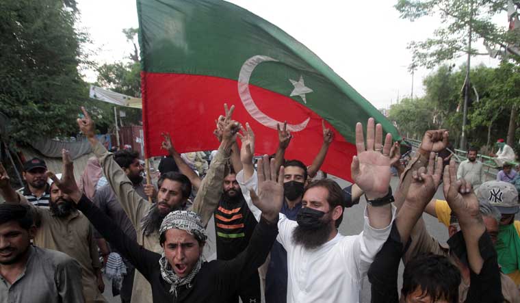Supporters of Pakistan's former Prime Minister Imran Khan celebrate outside of Khan's house in Lahore after Supreme Court ruled that his arrest was illegal | Reuters