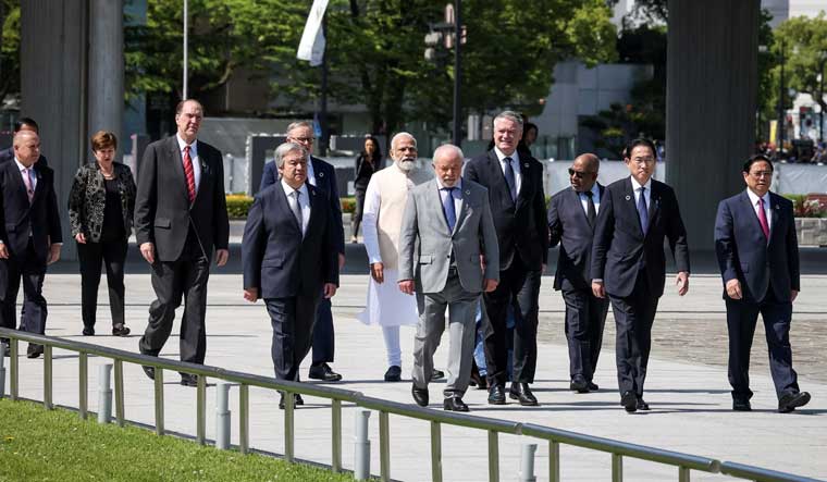Prime Minister Narendra Modi, along with leaders of other countries invited to the G7 Summit, walk out from the Peace Memorial Museum to a wreath-laying ceremony in the Peace Memorial Park at Hiroshima.  Japan's Prime Minister Fumio Kishida is also seen | Reuters