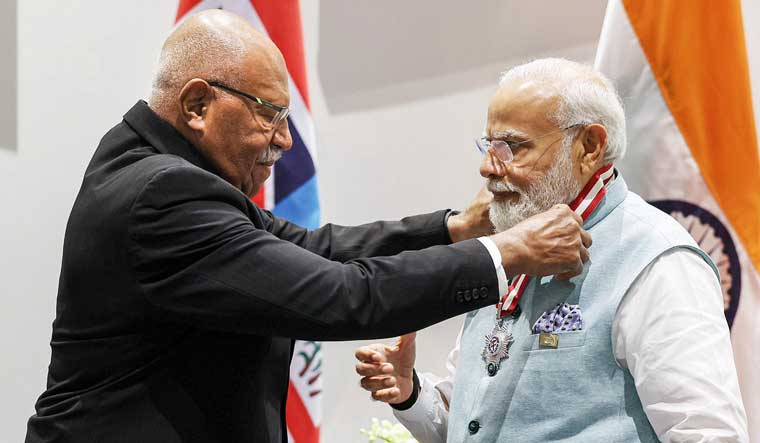  Prime Minister Narendra Modi being honoured with Fijis highest honor - the Companion of the Order of Fiji (CF) by Fiji PM Sitiveni Rubuka in Port Moresby | PTI