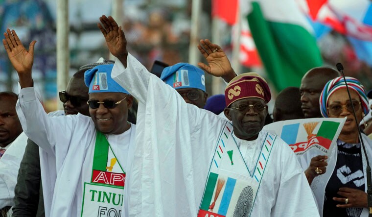 Bola Ahmed Tinubu, presidential candidate of the All Progressives Congress, Nigeria ruling party, right, and his running mate, Kashim Shettima, left, greets supporters during an election campaign rally at the Teslim Balogun Stadium in Lagos Nigeria, Tuesday, Feb. 21, 2023 | AP