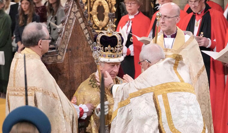King Charles III sits as he is crowned with St Edward's Crown by The Archbishop of Canterbury the Most Reverend Justin Welby during the coronation ceremony at Westminster Abbey, London, Saturday, May 6, 2023. AP/PTI(AP05_06_2023_000211A)
