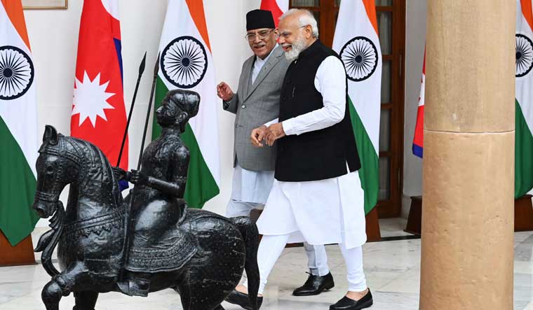 ndian Prime Minister Narendra Modi (R) and Nepal Prime Minister Pushpa Kamal Dahal walk before their meeting at Hyderabad House in New Delhi | PTI