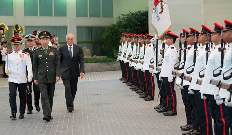 Chinese Defense Minister Gen. Li Shangfu, front center, inspects the honor guard with Singapore Defense Minister Ng Eng Hen, right, in Singapore, Thursday, June 1, 2023. China and Singapore laid the groundwork Friday for a hotline between the two countries that would establish a high-level communications link between Beijing and a close American partner in Asia at a time when Chinese tensions with Washington are high and dialogue has stalled. AP/PTI(AP06_01_2023_000037B)