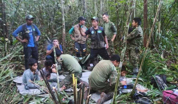 
Soldiers and Indigenous men tend to the four Indigenous children who were missing after a deadly plane crash, in the Solano jungle, Caqueta state, Colombia | AP
