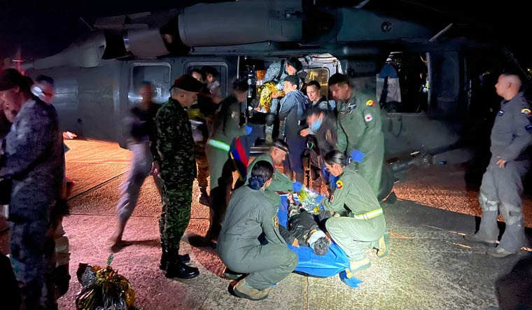 Members of Colombian Army checking one of the four children who were found alive after being lost for 40 days in the Amazon rainforest following a plane crash | AFP
