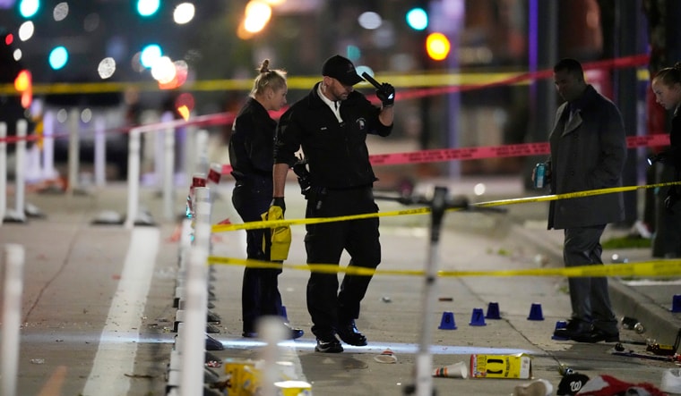 Denver Police Department investigators work the scene of a mass shooting along Market Street between 20th and 21st avenues during a celebration after the Denver Nuggets won the team's first NBA Championship early Tuesday, June 13, 2023, in Denver. (AP Photo/David Zalubowski)