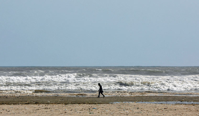 A man walks along Clifton beach, after a ban was imposed on coastal activities following the cyclonic storm, Biparjoy, over the Arabian Sea, in Karachi, Pakistan June 12, 2023 | Reuters