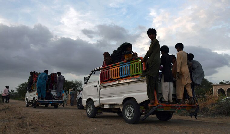 Local residents travel in vehicles as they evacuate the area due to Cyclone Biparjoy approaching, at a costal area Golarchi in Badin district, in Pakistan's Sindh province, Tuesday, June 13, 2023 | AP