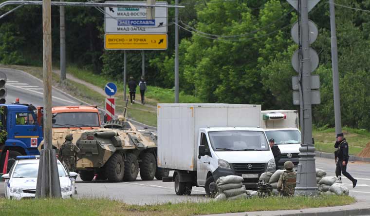 Russian army servicemen, and police officers guard the highway at the entrance to Moscow | AP