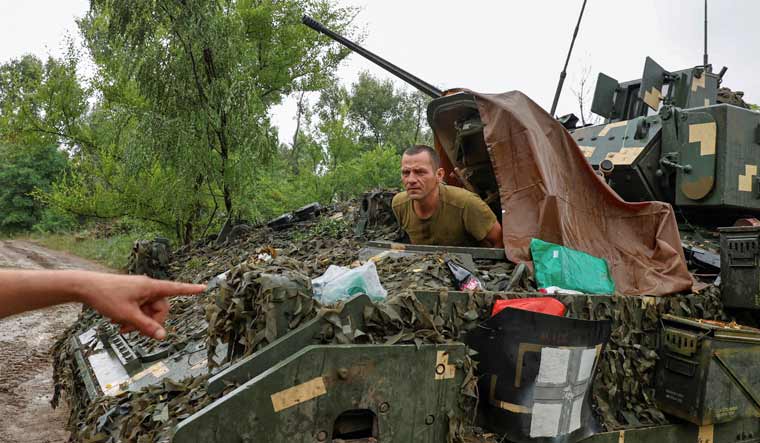 A Ukrainian serviceman of the 47th Magura Separate Mechanised Brigade sits inside a M2 Bradley infantry fighting vehicle at a position near a front line, amid Russia's attack on Ukraine, in Zaporizhzhia region, Ukraine June 26, 2023 | Reuters