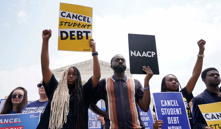People demonstrate outside the Supreme Court, Friday, June 30, 2023, in Washington. A sharply divided Supreme Court has ruled that the Biden administration overstepped its authority in trying to cancel or reduce student loan debts for millions of Americans. Conservative justices were in the majority in Friday's 6-3 decision that effectively killed the $400 billion plan that President Joe Biden announced last year. (AP Photo/Jacquelyn Martin)
