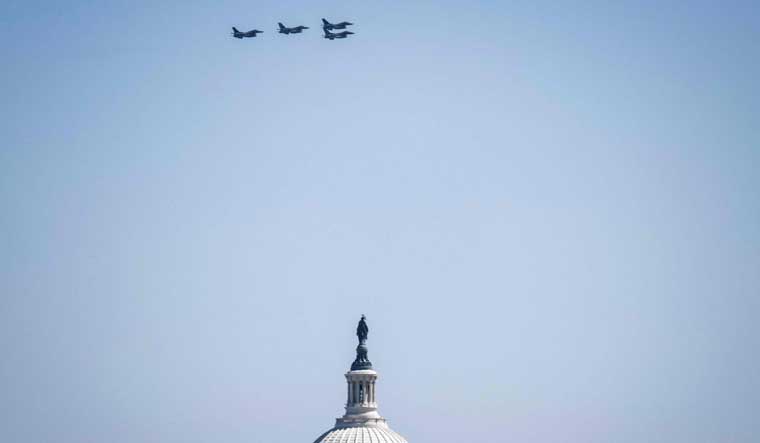 A group of F-16 aircraft are seen above the US Capitol building after a flyby over Nationals Park stadium in Washington, DC on March 30