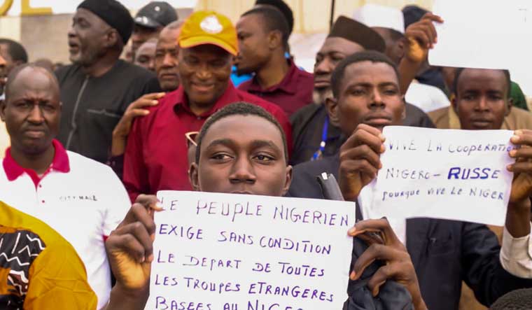 People of Niger with placards that read "The Nigeriens people demand without conditions the departure of all foreign troops based in Niger" and "Long Live the Russia-Niger cooperation" | AP
