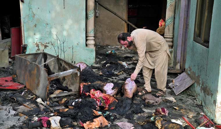 A Christian man checks a home vandalized by angry Muslim mob in Jaranwala near Faisalabad, Pakistan, Thursday, Aug. 17, 2023 | AP