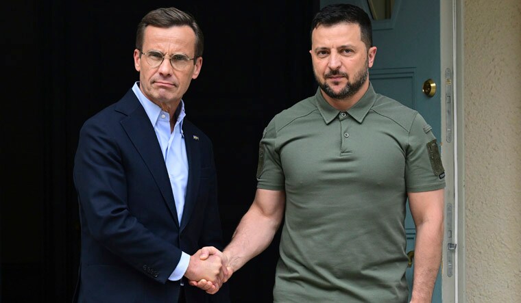 Ukrainian President Volodymyr Zelenskyy, right, shakes hands with Sweden Prime Minister Ulf Kristersson, during his visit to the Prime Minister country retreat, in Harpsund, Sweden, Saturday, Aug. 19, 2023. Zelenskyy is visiting Sweden for the first time since the full-scale Russian invasion of his country. (Jonas Ekstromer/TT News Agency via AP)