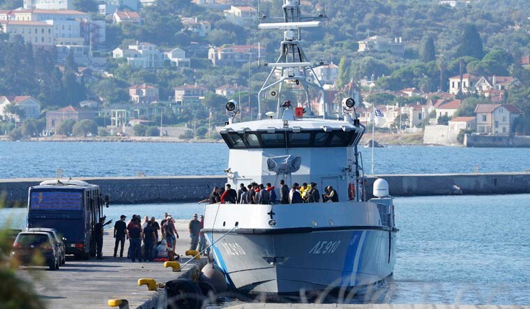 Migrants disembark from a Greek coast vessel after a rescue operation, at the port of Mytilene, on the northeastern Aegean Sea island of Lesbos, Greece, Monday, Aug. 28, 2023. Greek authorities say four people died and 18 were rescued Monday after a boat carrying migrants apparently sank northeast of the Greek island of Lesbos, which lies near the Turkish coast. (AP Photo/Panagiotis Balaskas)