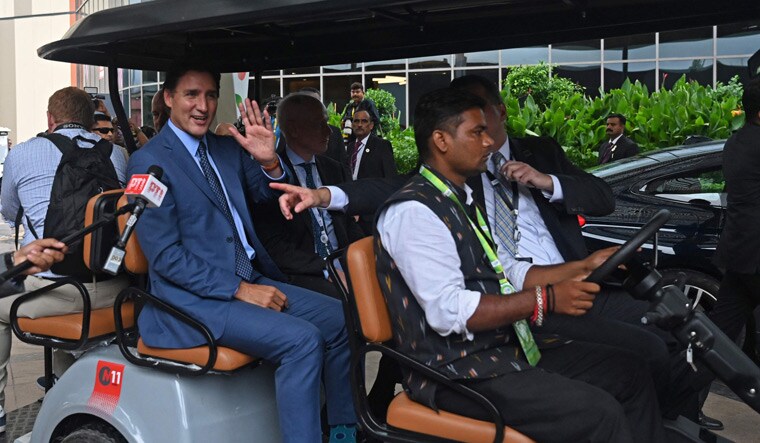 Canada's Prime Minister Justin Trudeau (C) arrives to attend a press conference after the closing session of the G20 summit in New Delhi | AFP