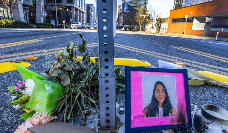 A photo of Jaahnavi Kandula is displayed with flowers, Sunday, Jan. 29, 2023 in Seattle, at the intersection where she was killed by a Seattle Police officer driving north while responding to a nearby medical incident | AP 