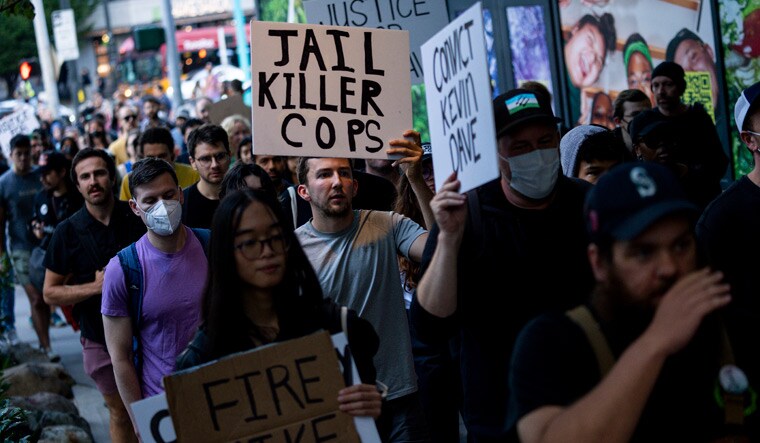 Protesters march through downtown Seattle after body camera footage was released of a Seattle police officer joking about the death of Jaahnavi Kandula went viral | AP