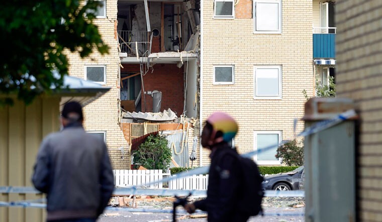 People look at the damages caused by an explosion in a residential building in the Ekholmen area, in Linkping, Sweden, Tuesday, Sept. 26, 2023 | AP