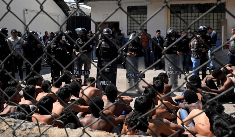 Ecuadorean police officers guard inmates at the Virgilio Guerrero Detention Centre for Adolescent Offenders after a riot attempt, in northern Quito | AFP