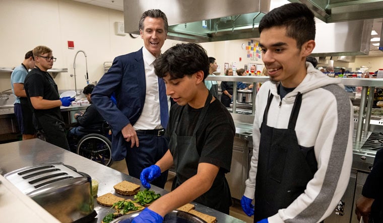 California Gov. Gavin Newsom talks with students in the Career Technical Education Pathways program at River City High School in West Sacramento, Calif., on Thursday, Aug. 31, 2023 | AP