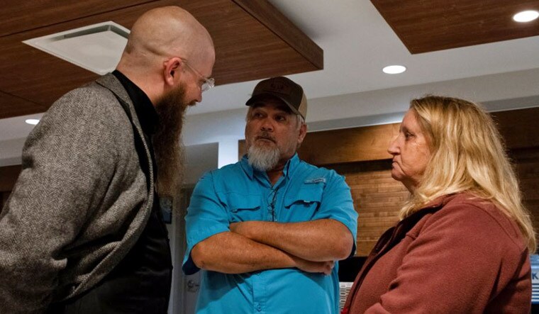 Jeff Hood, the spiritual advisor to Kenneth Smith, speaks with Mike and Kim Sennett at the Holiday Inn Express, following Smith's execution by asphyxiation using pure nitrogen at Holman Correctional Facility, in Atmore, Alabama, U.S. January 25, 2024 | Reuters