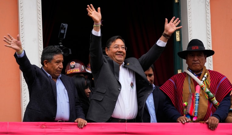 Bolivian President Luis Arce, center, and his Vice President David Choquehuanca, left, wave to supporters from a presidential palace balcony | AP