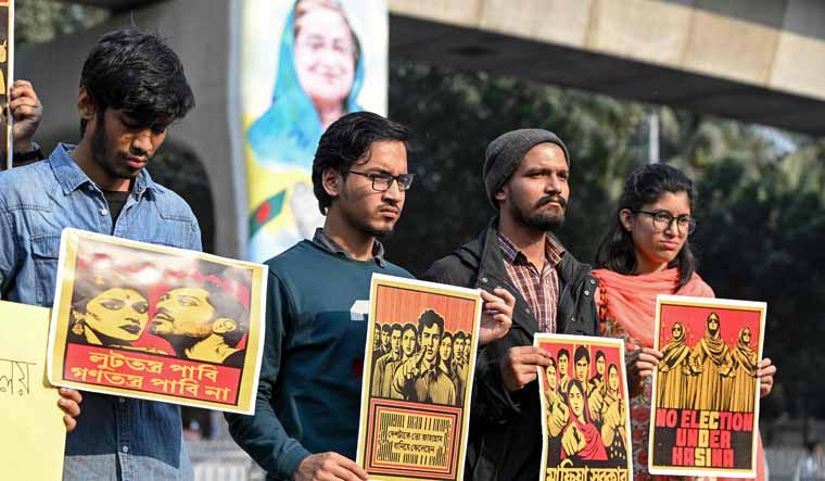 Dhaka University students hold a rally along a roadside in the capital on January 6, 2024 urging people to boycott Bangladesh's general elections on the eve of it's commencement | AFP