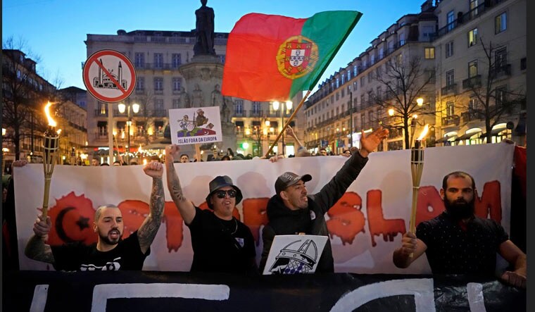 Supporters of the Portuguese nationalist movement 1143 carry torches and shout slogans during a protest march under the slogan "Stop Islam" in downtown Lisbon