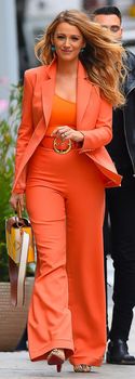 Blake Lively in an orange pantsuit | Getty Images