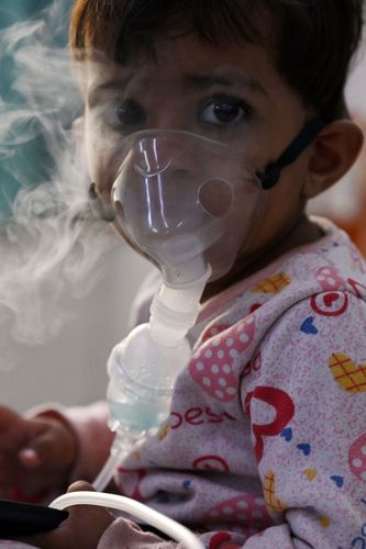 Breathe easy: A child breathes with the help of a nebuliser at Chacha Nehru Bal Chikitsalaya in Delhi | AFP