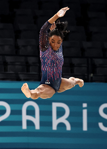 Pushing boundaries: Gymnast Simone Biles on the beam during training | Reuters