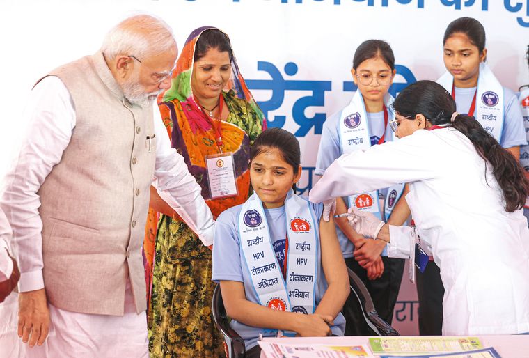 Making strides: Prime Minister Narendra Modi at a vaccination centre in Ajmer, Rajasthan, as a 14-year-old receives the HPV vaccine. In February, the government launched a nationwide vaccination drive, providing the vaccine free of cost to approximately 1.15 crore girls | PTI