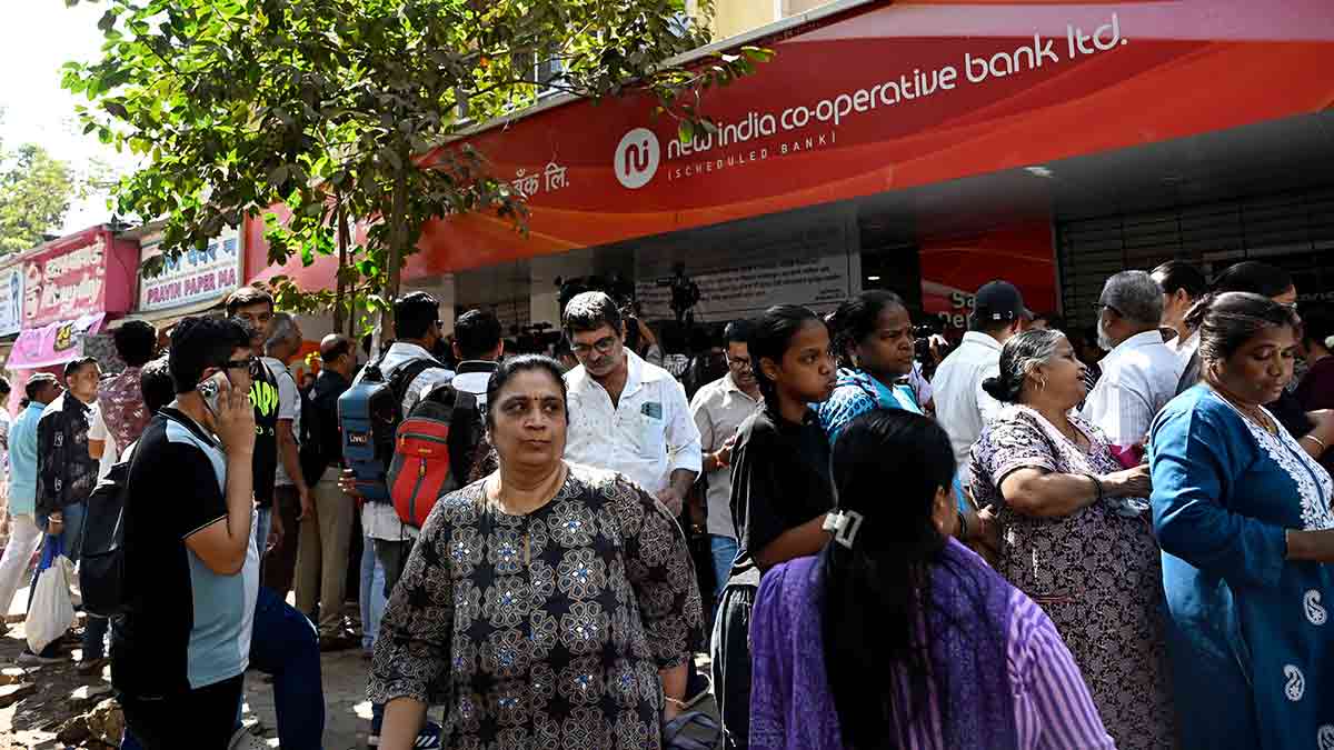 Frozen in fear: People gathered outside the fraud-hit New India Cooperative Bank in Mumbai. It was recently acquired by Saraswat Cooperative Bank, enabling account holders to access their deposits once more.
