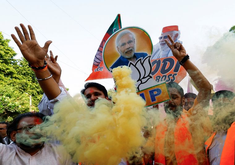 Victory parade: BJP supporters celebrate outside the party headquarters in Delhi | Reuters