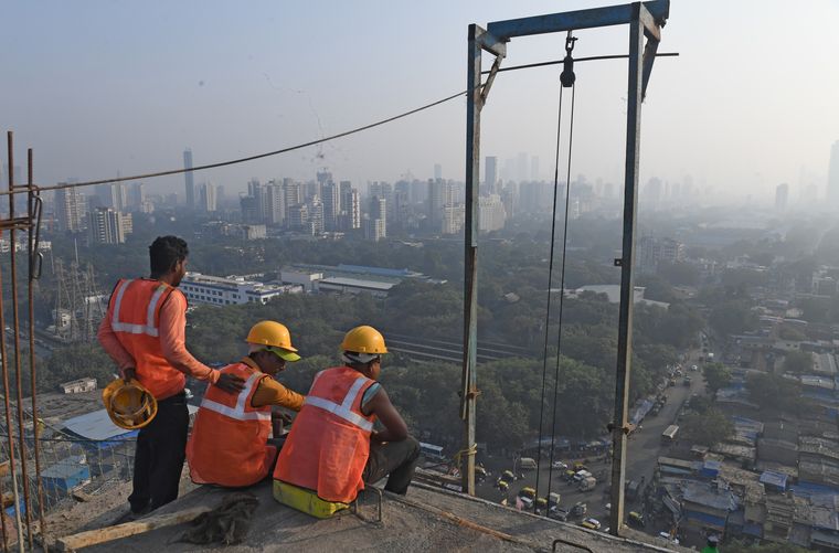 Changing megalopolis: Workers take a break at the construction site of a high-rise in Mumbai that overlooks Dharavi, one of Asia’s largest slums | Amey Mansabdar