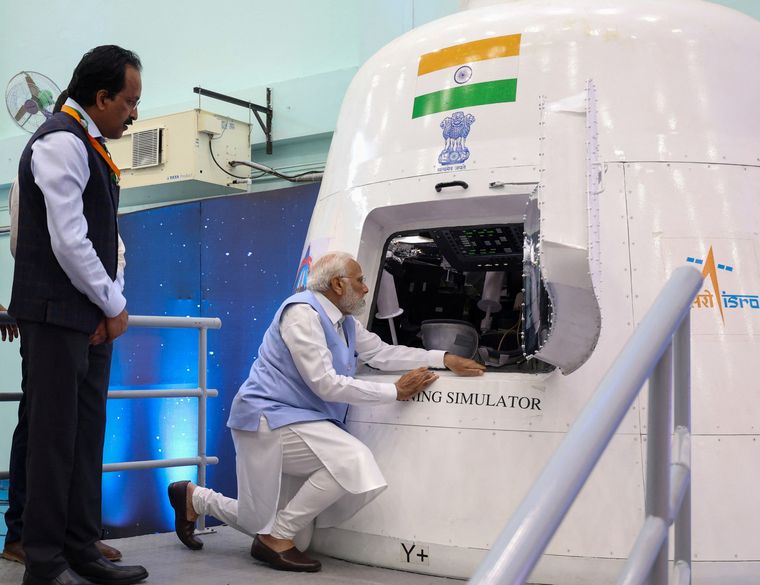 Hands-on leadership: Prime Minister Narendra Modi examines a simulator as ISRO Chairman S. Somanath looks on | PIB