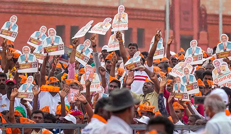 Saffron surge: BJP supporters welcome Prime Minister Narendra Modi at an event in Tiruppur | PTI